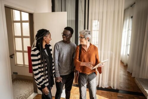 Real estate agent showing a home to a couple