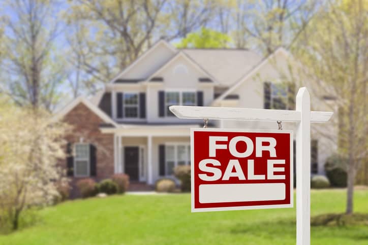 Home For Sale real estate sign in front of single family house