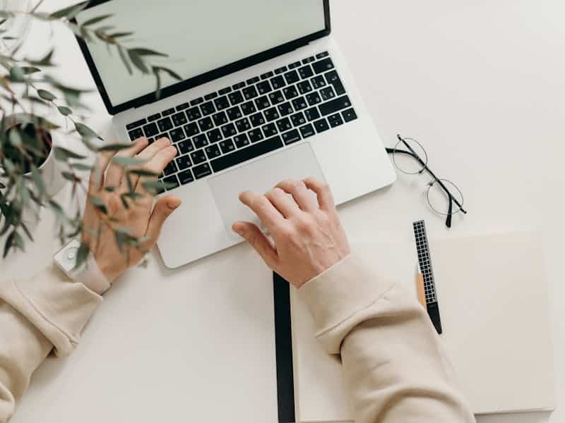 how to go paperless image of hands on laptop