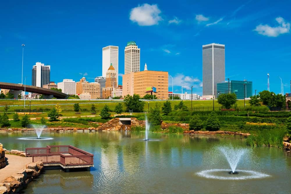 OK: Tulsa skyline with a park, pond, and fountains in the foreground.