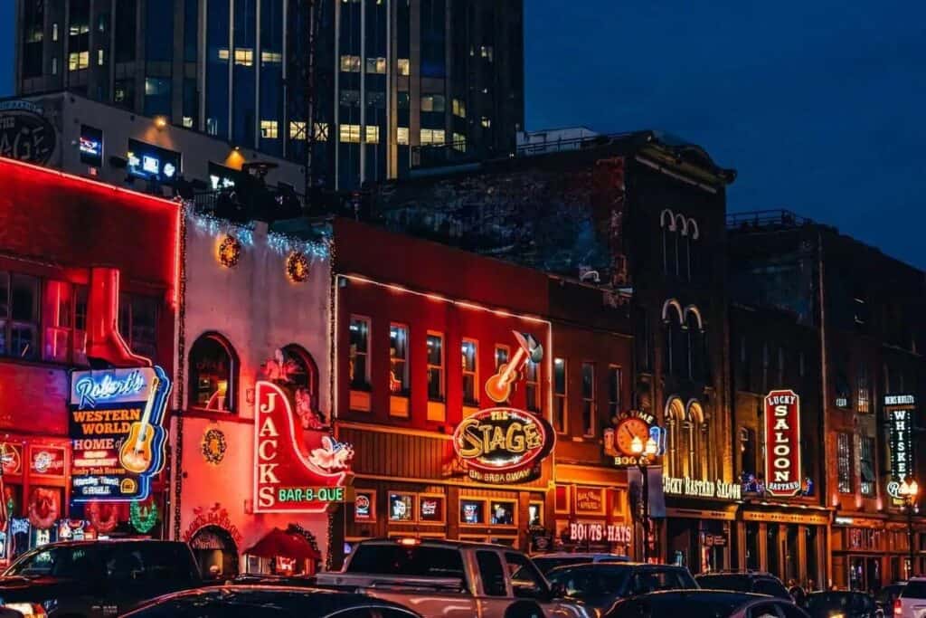 Glowing lights on a busy night at the bars and honky-tonks in the country music center, Broadway Street, in Downtown Nashville, Tennessee.